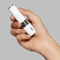 Braun Gesichtsepilierer in einer Hand gehalten, der die kompakte Größe und das elegante Design hervorhebt.