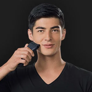 Braun Rasierer im Einsatz, ein Mann rasiert sich mit dem Gerät vor einem dunklen Hintergrund.