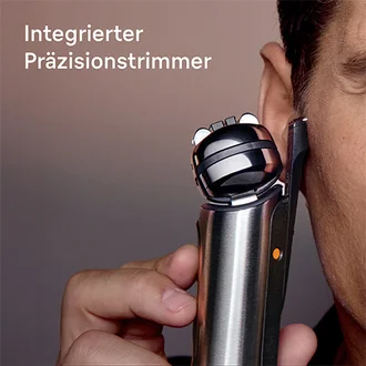 Ein Mann verwendet den Braun NEVO Rasierer mit integriertem Langhaarschneider für präzises Trimmen der Koteletten.